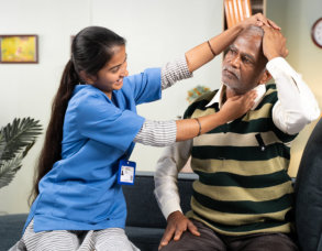 hysician nurse helping senior man for neck exercise