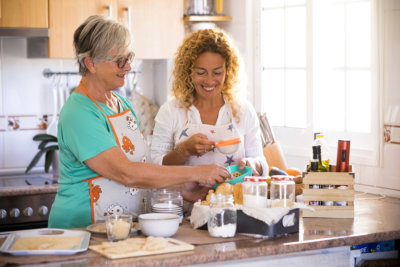 woman and senior woman preparing food